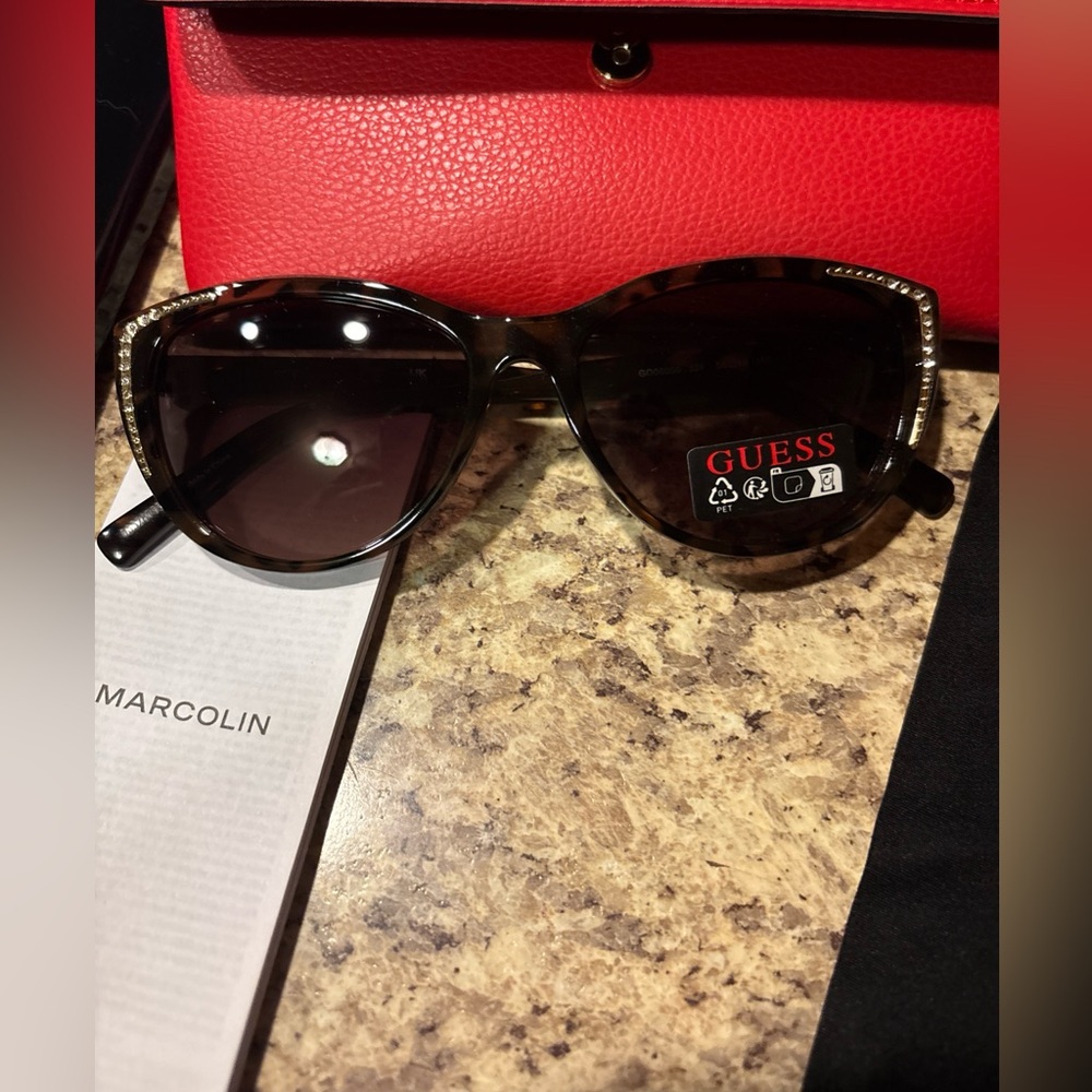 Guess Women's Tortoise Shell Sunglasses with gold embellishments per lens.